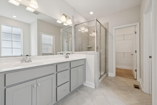 105 Artie Lee Ln, Nolensville, TN 37135 - bathroom featuring a stall shower, double vanity, tile patterned flooring, a walk in closet, and recessed lighting