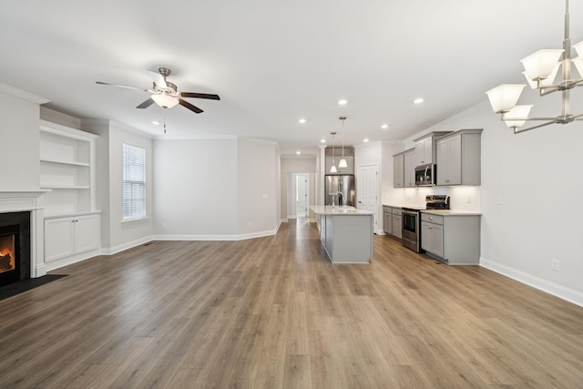 105 Artie Lee Ln, Nolensville, TN 37135 - unfurnished living room with a fireplace with flush hearth, ornamental molding, light wood finished floors, recessed lighting, and baseboards