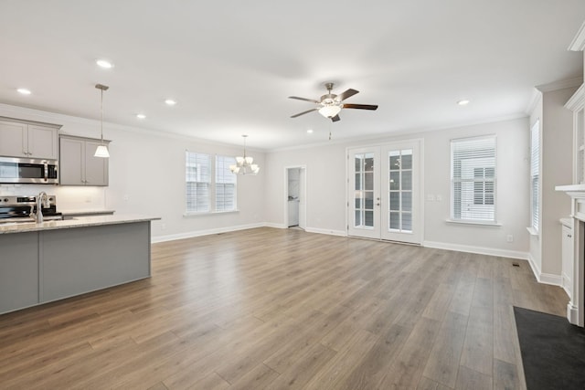 105 Artie Lee Ln, Nolensville, TN 37135 - unfurnished living room with ceiling fan, a fireplace with flush hearth, wood finished floors, recessed lighting, and crown molding