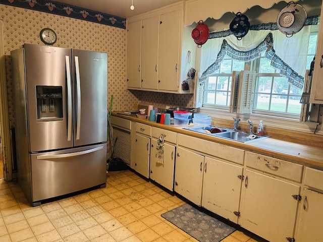1102 Manor Rd, Columbia, TN 38401 - kitchen featuring stainless steel refrigerator with ice dispenser, a sink, light flooring, wallpapered walls, and light countertops