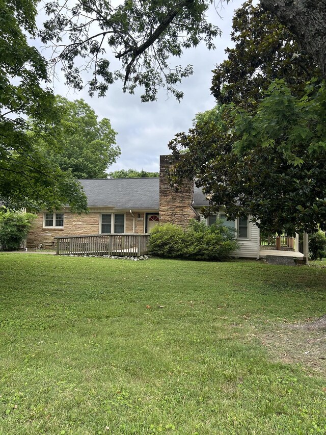 1102 Manor Rd, Columbia, TN 38401 - view of front of home featuring a front lawn, a wooden deck, and a chimney