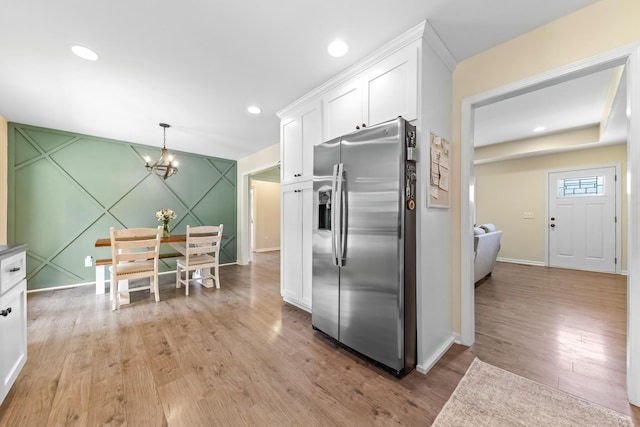 2034 Glencoe Rd, Culleoka, TN 38451 - kitchen with stainless steel refrigerator with ice dispenser, a chandelier, white cabinetry, light wood finished floors, and recessed lighting