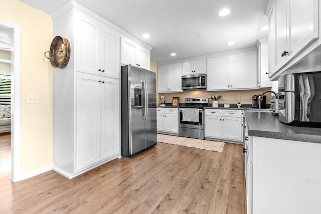 2034 Glencoe Rd, Culleoka, TN 38451 - kitchen with appliances with stainless steel finishes, dark countertops, light wood-style floors, white cabinetry, and recessed lighting