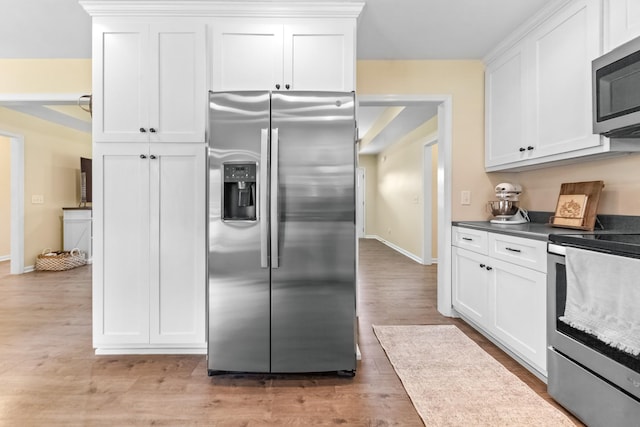 2034 Glencoe Rd, Culleoka, TN 38451 - kitchen with appliances with stainless steel finishes, white cabinetry, and light wood finished floors