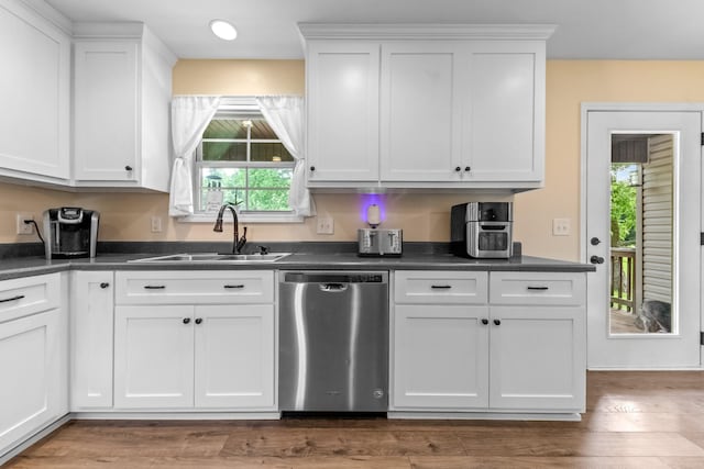 2034 Glencoe Rd, Culleoka, TN 38451 - kitchen with stainless steel dishwasher, dark countertops, and white cabinetry