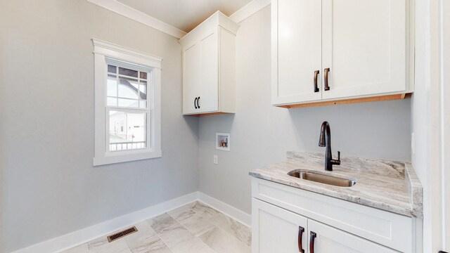 140 Edgewater Way, Jasper, TN 37347 - washroom featuring washer hookup, baseboards, light marble finish flooring, and cabinet space