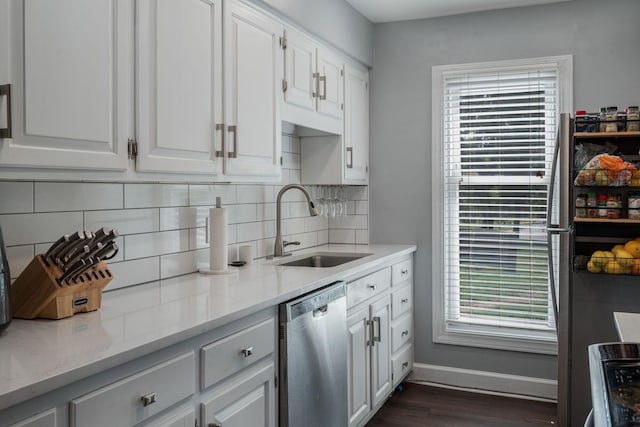 5025 Hillsboro Pike Unit 1A, Nashville, TN 37215 - kitchen with appliances with stainless steel finishes, a sink, decorative backsplash, baseboards, and white cabinets
