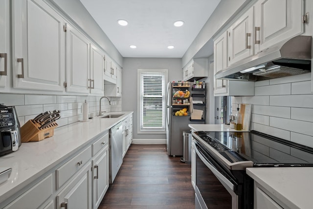 5025 Hillsboro Pike Unit 1A, Nashville, TN 37215 - kitchen featuring stainless steel appliances, a sink, under cabinet range hood, white cabinetry, and dark wood finished floors