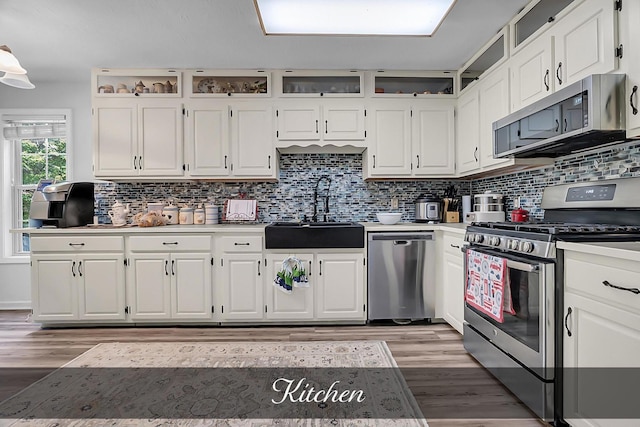 81 Pine Tree Cir, Crossville, TN 38571 - kitchen with appliances with stainless steel finishes, a sink, white cabinetry, light wood finished floors, and light countertops