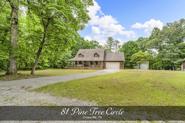 81 Pine Tree Cir, Crossville, TN 38571 - view of front of house with driveway, covered porch, a front yard, and a garage