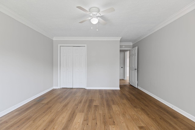 3540 Lake Towne Dr, Antioch, TN 37013 - unfurnished bedroom with wood finished floors, baseboards, a closet, crown molding, and a textured ceiling