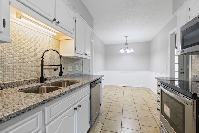 3540 Lake Towne Dr, Antioch, TN 37013 - kitchen featuring a sink, stainless steel appliances, white cabinetry, backsplash, and a chandelier