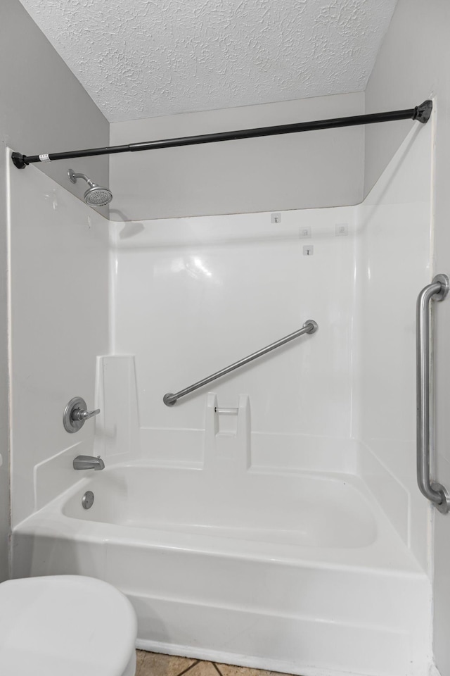 3540 Lake Towne Dr, Antioch, TN 37013 - bathroom with a textured ceiling, shower / bathtub combination, toilet, and tile patterned flooring
