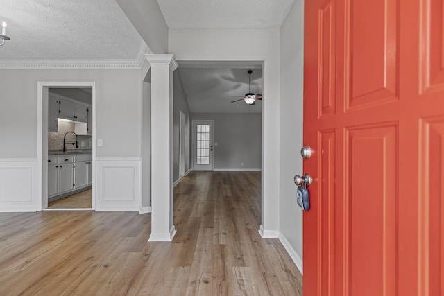 3540 Lake Towne Dr, Antioch, TN 37013 - foyer entrance with a ceiling fan, light wood-style floors, ornate columns, a textured ceiling, and baseboards