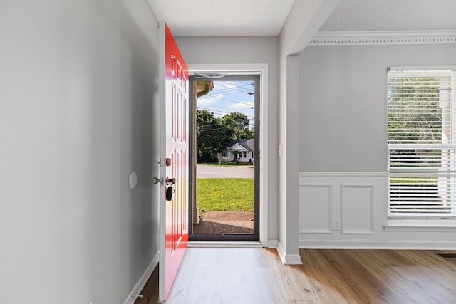 3540 Lake Towne Dr, Antioch, TN 37013 - entrance foyer featuring wood finished floors, plenty of natural light, a textured ceiling, ornamental molding, and wainscoting