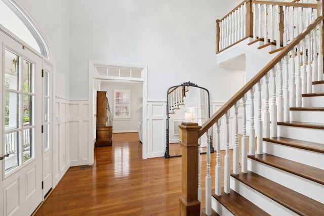 200 Addison Ave, Franklin, TN 37064 - entryway featuring a towering ceiling, wood finished floors, stairway, a decorative wall, and a wainscoted wall