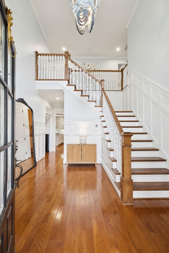 200 Addison Ave, Franklin, TN 37064 - foyer entrance with hardwood / wood-style floors, stairway, a chandelier, a decorative wall, and a towering ceiling