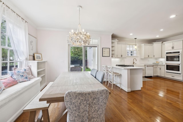 200 Addison Ave, Franklin, TN 37064 - dining room with ornamental molding, a chandelier, wood finished floors, and recessed lighting