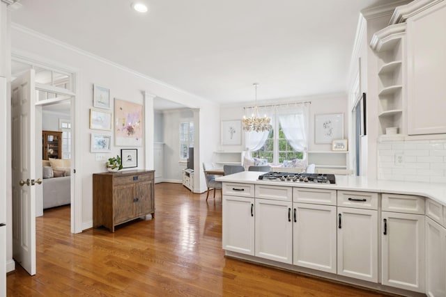 200 Addison Ave, Franklin, TN 37064 - kitchen featuring stainless steel gas cooktop, light wood-style floors, a peninsula, ornamental molding, and light countertops