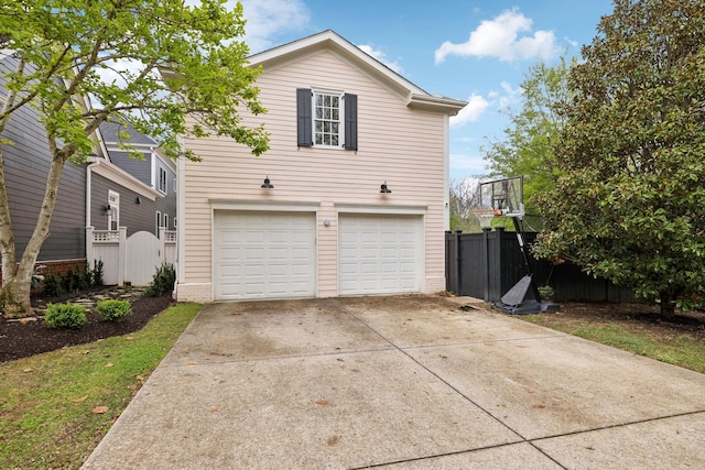 200 Addison Ave, Franklin, TN 37064 - view of property exterior with a garage, concrete driveway, and a gate