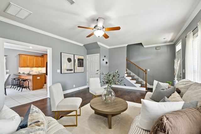 5239 Starnes Dr, Murfreesboro, TN 37128 - living area featuring stairway, crown molding, ceiling fan, light wood-style flooring, and baseboards