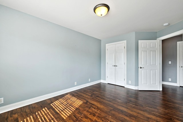 5239 Starnes Dr, Murfreesboro, TN 37128 - unfurnished bedroom with baseboards, dark wood-type flooring, and a closet
