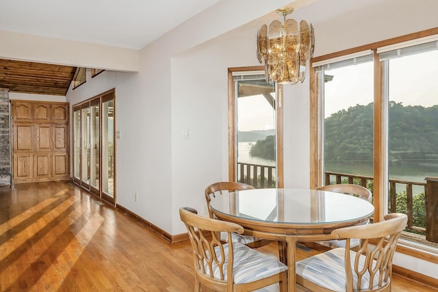 1634 Falling Water Rd, Sparta, TN 38583 - dining area featuring a chandelier, baseboards, light wood finished floors, and lofted ceiling