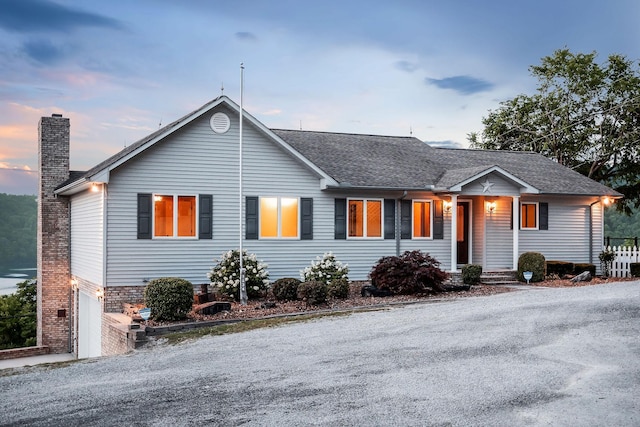 1634 Falling Water Rd, Sparta, TN 38583 - view of front of house with a chimney, an attached garage, driveway, and a shingled roof