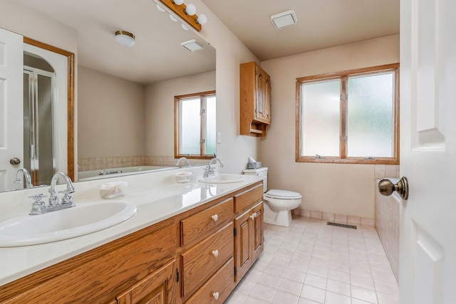 1634 Falling Water Rd, Sparta, TN 38583 - bathroom with double vanity, a bath, toilet, a shower stall, and tile patterned floors