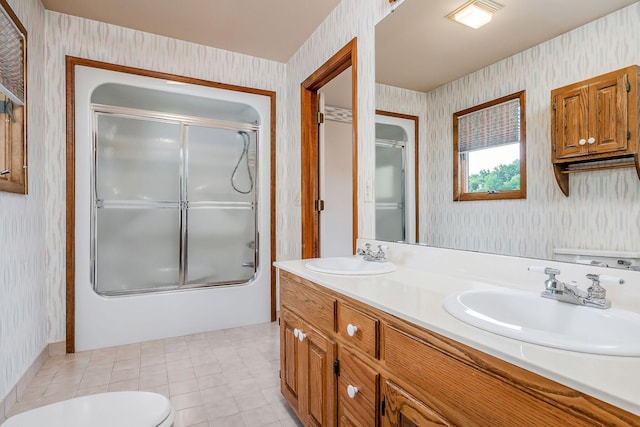 1634 Falling Water Rd, Sparta, TN 38583 - bathroom featuring wallpapered walls, toilet, double vanity, and combined bath / shower with glass door