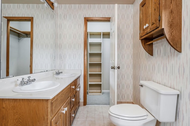 1634 Falling Water Rd, Sparta, TN 38583 - full bathroom featuring wallpapered walls, toilet, double vanity, tile patterned floors, and a spacious closet