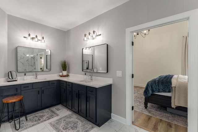 115 Wise Rd, Franklin, TN 37064 - bathroom featuring double vanity, marble look tiles, baseboards, and ensuite bathroom