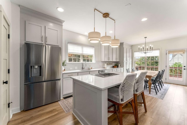 115 Wise Rd, Franklin, TN 37064 - kitchen featuring stainless steel refrigerator with ice dispenser, light wood finished floors, a center island, recessed lighting, and hanging light fixtures