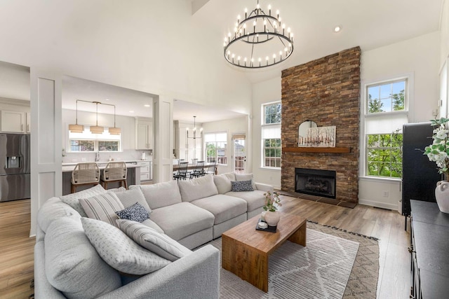 115 Wise Rd, Franklin, TN 37064 - living room featuring a chandelier, plenty of natural light, light wood-style flooring, a towering ceiling, and recessed lighting