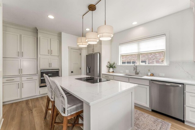 115 Wise Rd, Franklin, TN 37064 - kitchen with stainless steel appliances, a sink, a center island, a breakfast bar, and recessed lighting