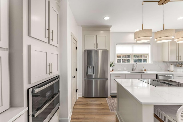 115 Wise Rd, Franklin, TN 37064 - kitchen featuring stainless steel appliances, a sink, light wood-style flooring, backsplash, and recessed lighting