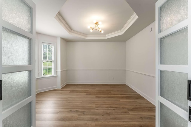 115 Wise Rd, Franklin, TN 37064 - spare room featuring ornamental molding, a tray ceiling, a chandelier, wood finished floors, and baseboards