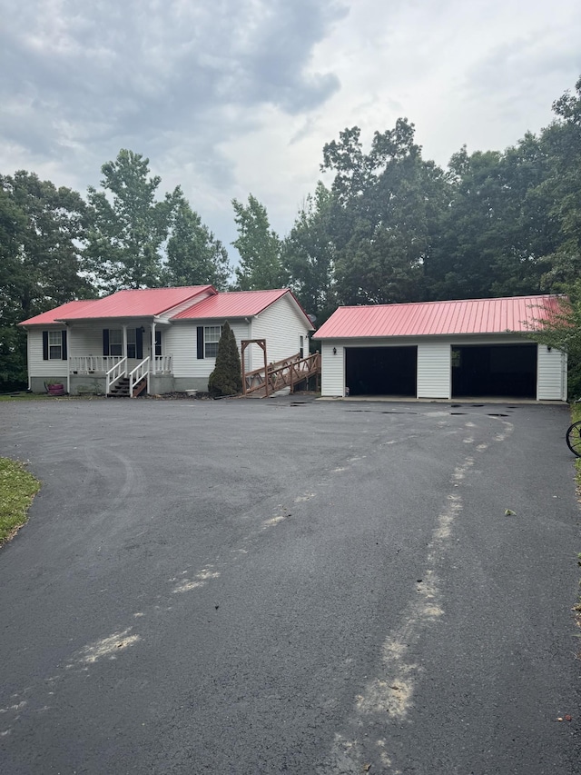 2080 Winsett Rd, Springville, TN 38256 - view of front of home featuring an outbuilding, metal roof, a garage, and covered porch