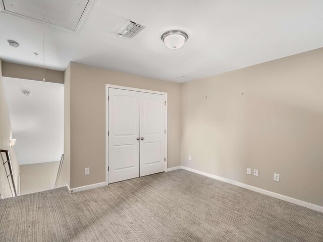 3031 Joseph Dr, Spring Hill, TN 37174 - unfurnished bedroom featuring attic access, baseboards, carpet floors, and a closet