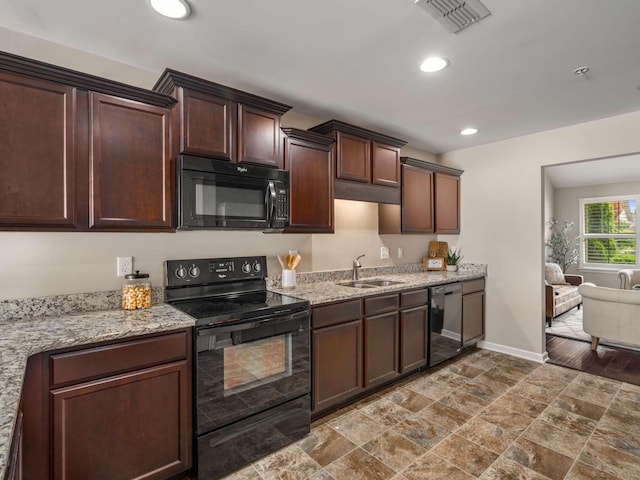 3031 Joseph Dr, Spring Hill, TN 37174 - kitchen with black appliances, a sink, baseboards, dark brown cabinets, and recessed lighting