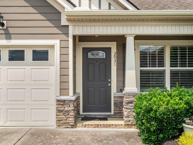 3031 Joseph Dr, Spring Hill, TN 37174 - doorway to property with stone siding, a garage, a porch, and roof with shingles