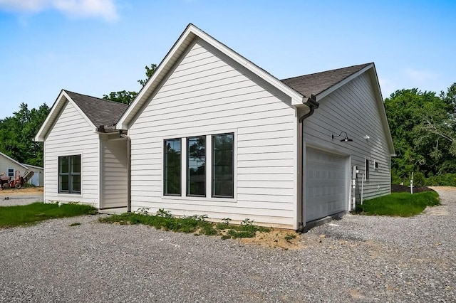 363 S Walnut Ave, Cookeville, TN 38501 - view of property exterior with gravel driveway, roof with shingles, and an attached garage