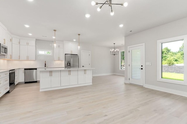363 S Walnut Ave, Cookeville, TN 38501 - kitchen featuring stainless steel appliances, a chandelier, backsplash, a center island, and plenty of natural light