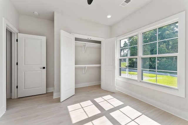 363 S Walnut Ave, Cookeville, TN 38501 - unfurnished bedroom featuring multiple windows, light wood-style floors, baseboards, and a closet