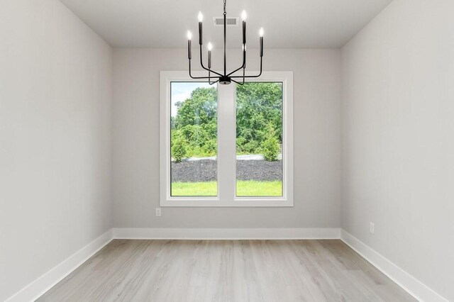 363 S Walnut Ave, Cookeville, TN 38501 - unfurnished room with a chandelier, light wood-style floors, and baseboards