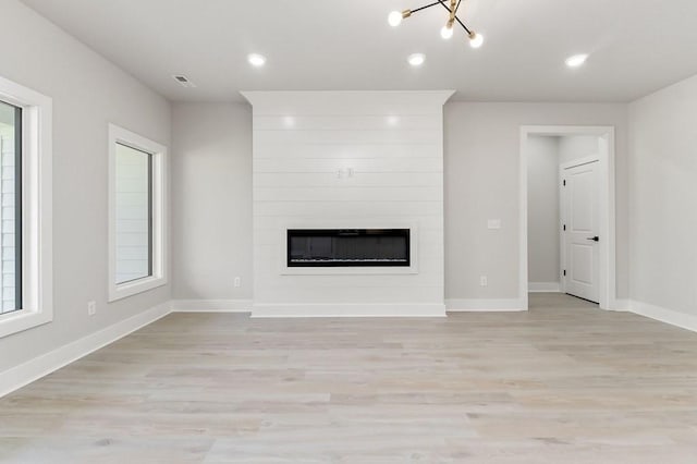 363 S Walnut Ave, Cookeville, TN 38501 - unfurnished living room featuring light wood-style floors, a fireplace, baseboards, recessed lighting, and a chandelier