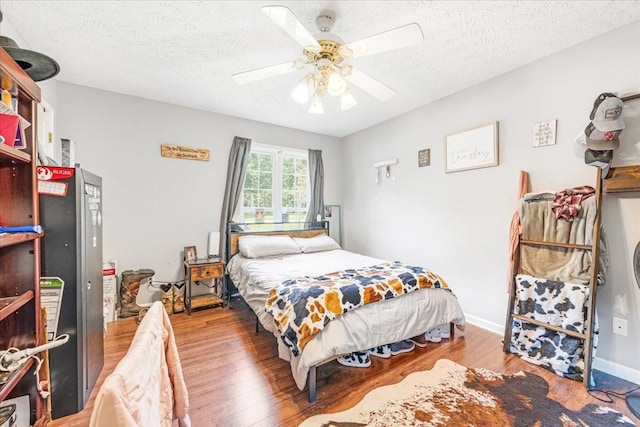 431 Jack Thomas Dr, Manchester, TN 37355 - bedroom featuring wood finished floors, a textured ceiling, and ceiling fan