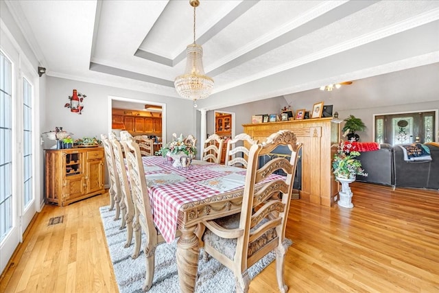 431 Jack Thomas Dr, Manchester, TN 37355 - dining area featuring a chandelier, light wood-type flooring, a tray ceiling, and crown molding