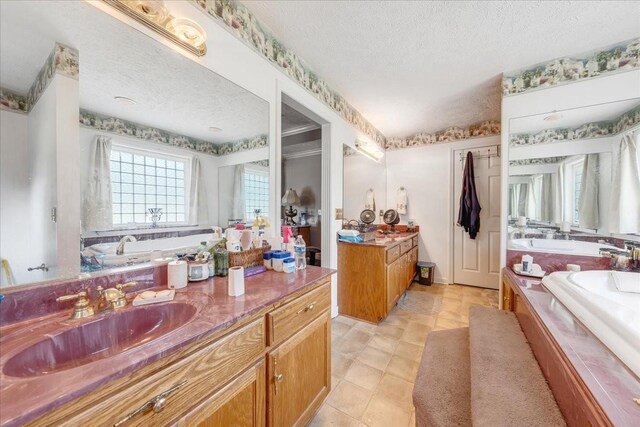 431 Jack Thomas Dr, Manchester, TN 37355 - bathroom with a textured ceiling, a garden tub, vanity, a shower stall, and tile patterned floors