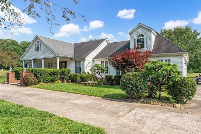 431 Jack Thomas Dr, Manchester, TN 37355 - neoclassical home featuring a front lawn, covered porch, and a shingled roof